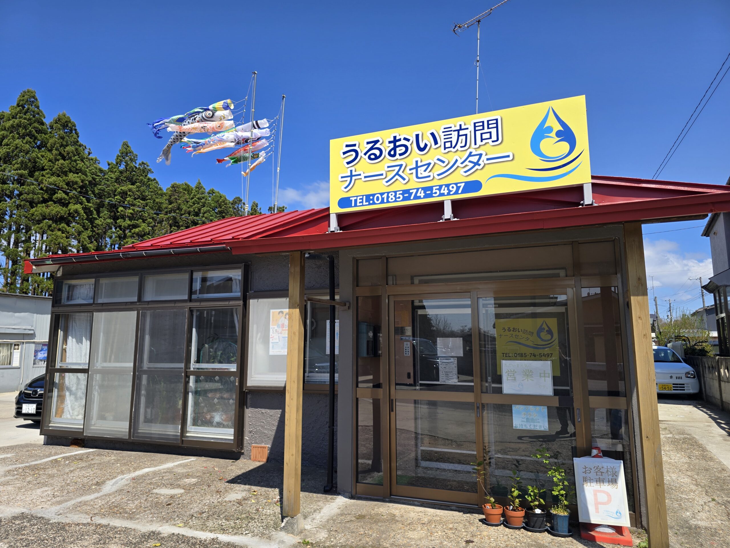 能代市の訪問看護ステーション うるおい訪問ナースセンターの外観と鯉のぼり